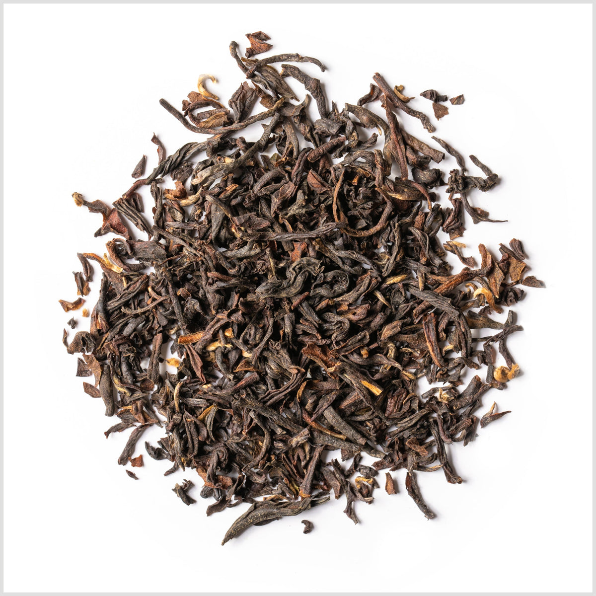 A pile of loose-leaf 2nd Flush Darjeeling tea arranged in a circular mound on a solid white background.