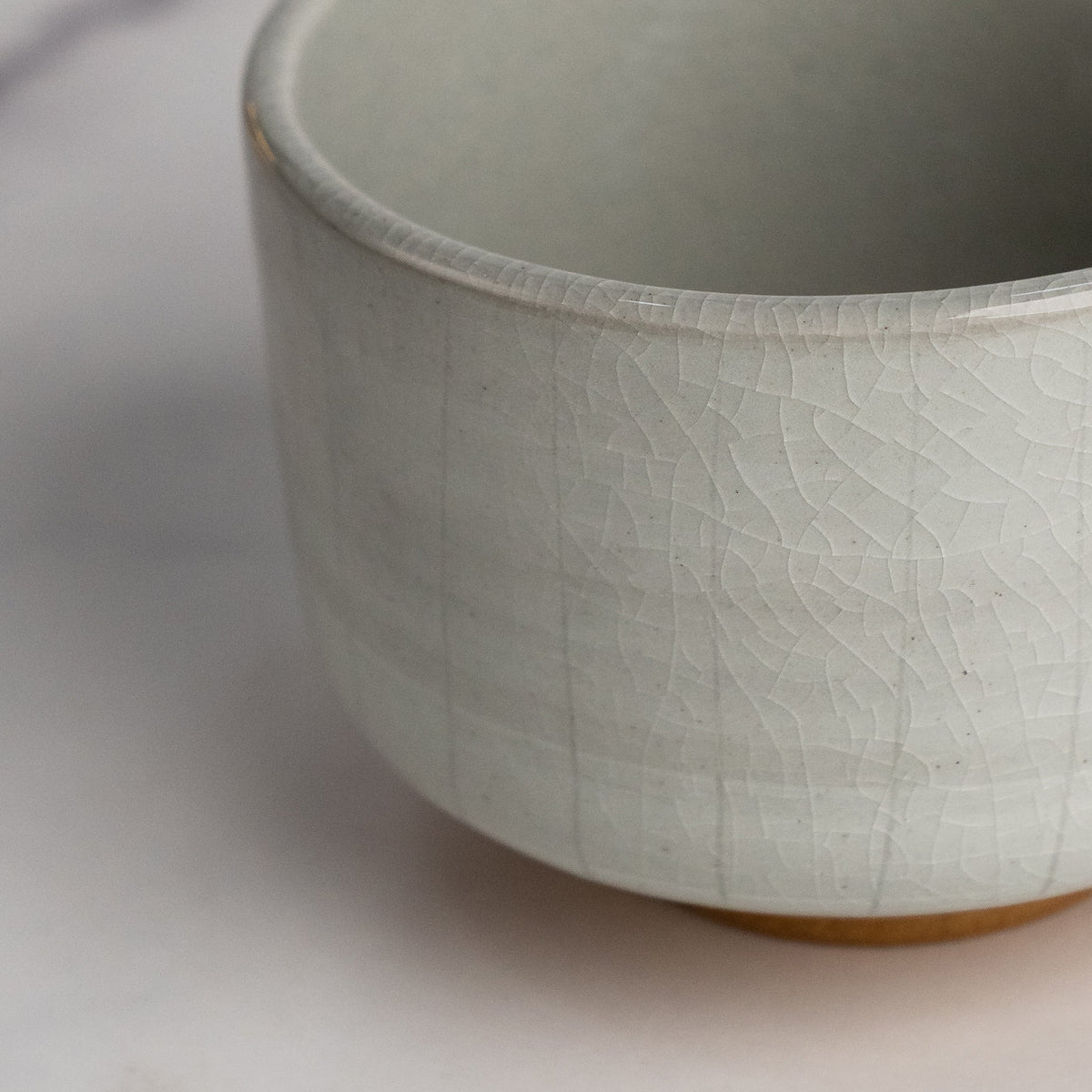 Close-up of a textured ceramic bowl on a light background